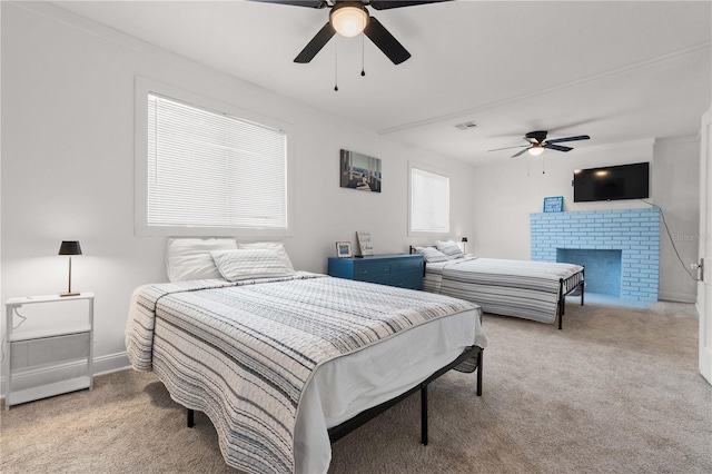 bedroom with carpet floors, ceiling fan, a brick fireplace, and baseboards