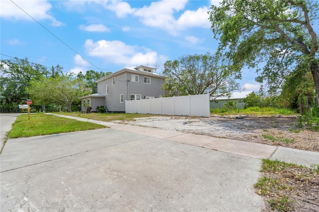 view of home's exterior with fence