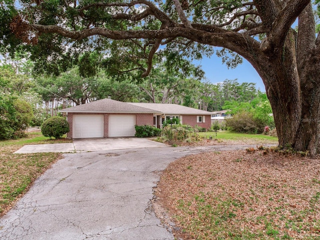 7216 N Mobley Rd, Odessa, FL 33556 - single story home with brick siding, driveway, and a garage