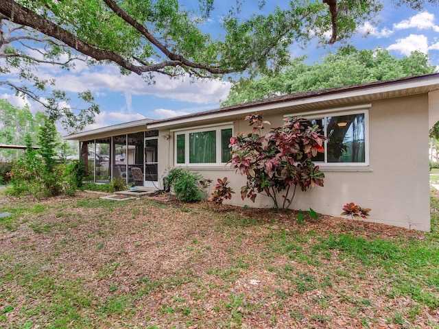 7216 N Mobley Rd, Odessa, FL 33556 - rear view of property featuring a sunroom and concrete block siding