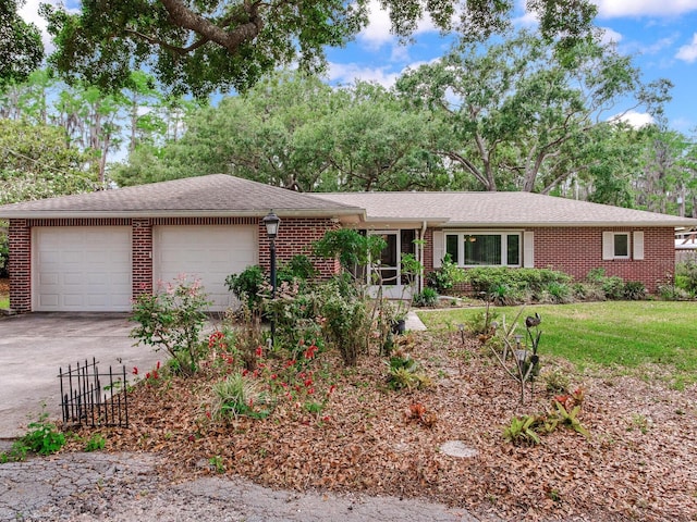 7216 N Mobley Rd, Odessa, FL 33556 - ranch-style house with brick siding, an attached garage, concrete driveway, and fence