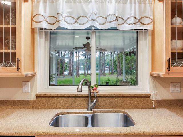 7216 N Mobley Rd, Odessa, FL 33556 - kitchen view of a sink, glass insert cabinets, and a ceiling fan