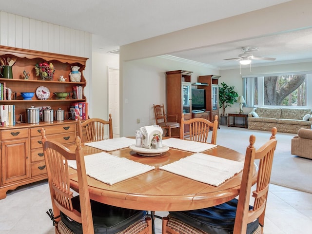 7216 N Mobley Rd, Odessa, FL 33556 - dining area featuring light tile patterned flooring, a ceiling fan, light carpet, and crown molding