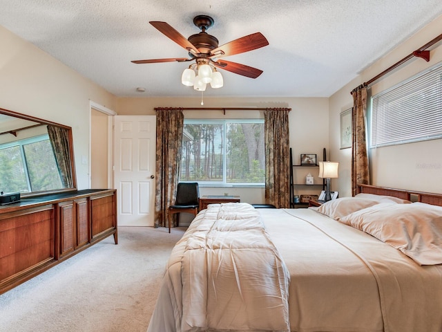 7216 N Mobley Rd, Odessa, FL 33556 - bedroom with light colored carpet, a textured ceiling, and ceiling fan