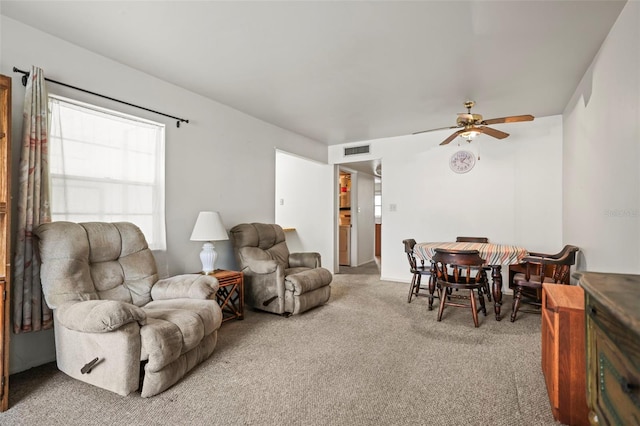 carpeted living room featuring a ceiling fan
