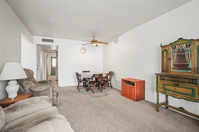 living area with carpet floors and a ceiling fan