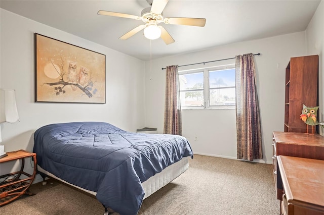 carpeted bedroom with a ceiling fan and baseboards