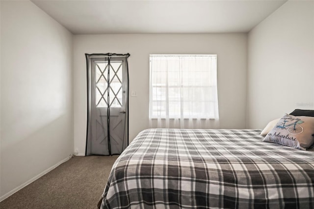 carpeted bedroom with baseboards