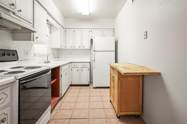 kitchen featuring freestanding refrigerator, electric stove, under cabinet range hood, a sink, and white cabinetry