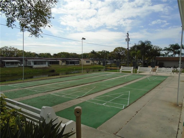 view of home's community featuring shuffleboard and a water view