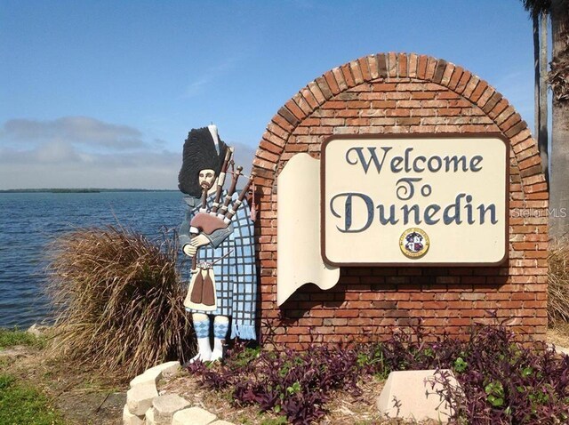 community sign with a water view