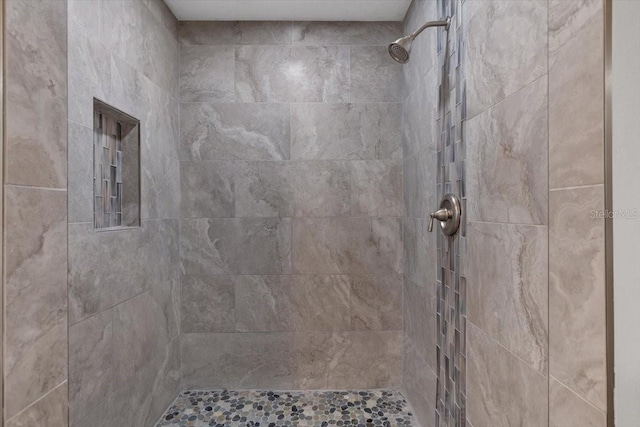 bathroom with tiled shower