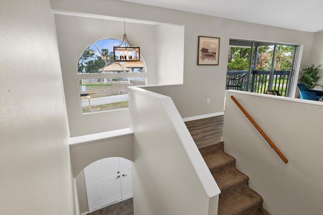 stairway with baseboards and wood finished floors
