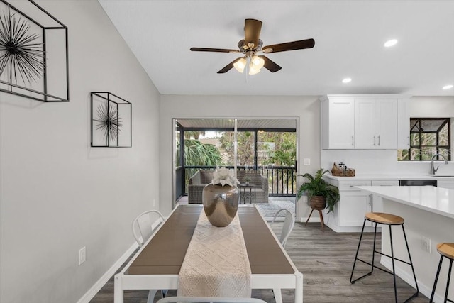 dining space with wood finished floors, ceiling fan, recessed lighting, and baseboards