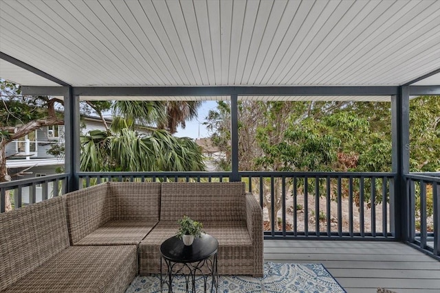 unfurnished sunroom featuring an outdoor living space and healthy amount of natural light