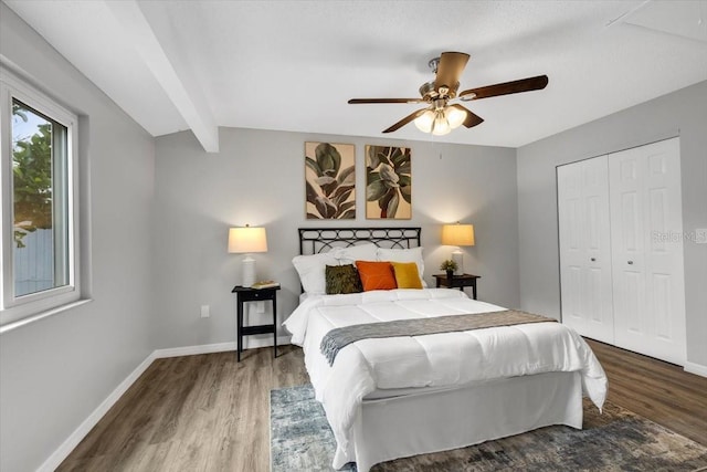 bedroom with wood finished floors, baseboards, a closet, and a ceiling fan