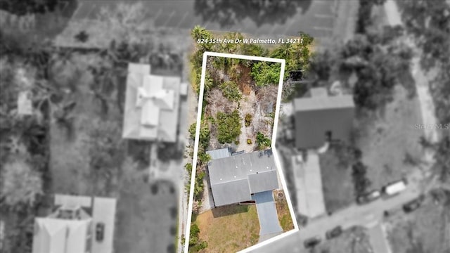 aerial view of property and surrounding area featuring property parcel outlined
