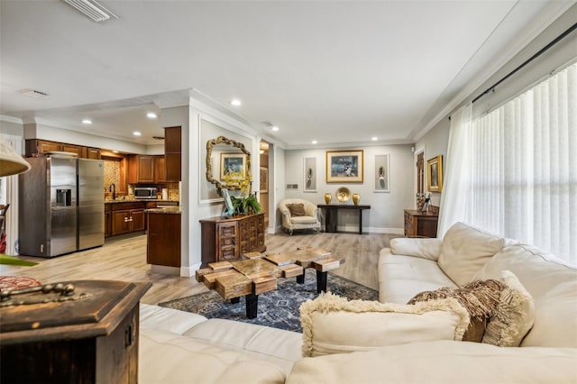 5245 18th St N, Saint Petersburg, FL 33714 - living room featuring light wood-type flooring, crown molding, baseboards, and recessed lighting