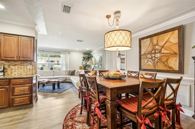 5245 18th St N, Saint Petersburg, FL 33714 - dining area with crown molding, light wood-style flooring, and recessed lighting