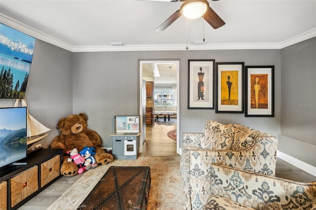 5245 18th St N, Saint Petersburg, FL 33714 - living area featuring ornamental molding, wood finished floors, ceiling fan, and baseboards