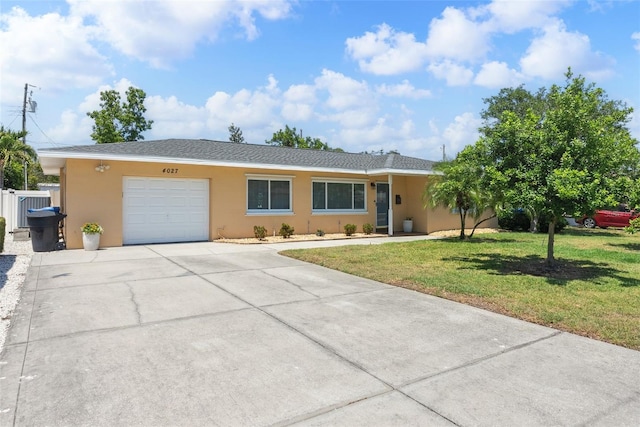 4027 25th Ave N, Saint Petersburg, FL 33713 - ranch-style house with an attached garage, concrete driveway, stucco siding, and a front yard