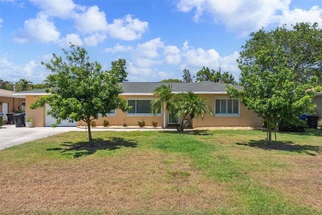 4027 25th Ave N, Saint Petersburg, FL 33713 - view of front of house with driveway, a garage, a front lawn, and stucco siding