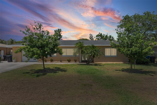 4027 25th Ave N, Saint Petersburg, FL 33713 - view of front facade featuring concrete driveway, a lawn, a garage, and stucco siding