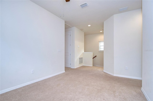 unfurnished room with recessed lighting, light carpet, and baseboards