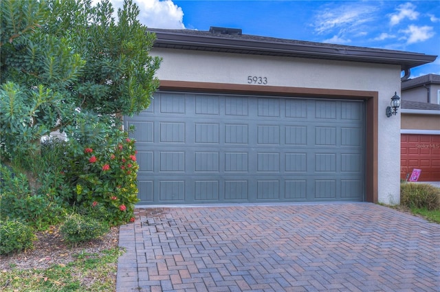 garage featuring decorative driveway