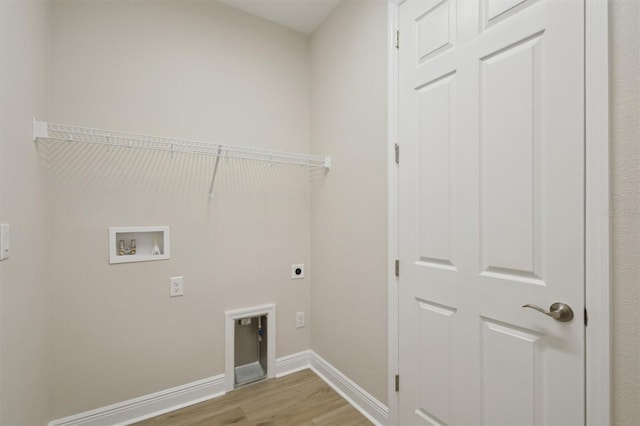 washroom featuring hookup for an electric dryer, light wood finished floors, hookup for a washing machine, and baseboards