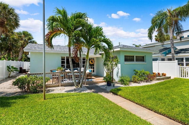 view of front facade featuring a wooden deck and stucco siding