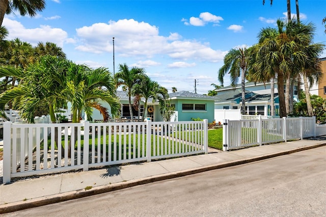 106 13th Ave, St Pete Beach, FL 33706 - view of front of home with a fenced front yard and stucco siding