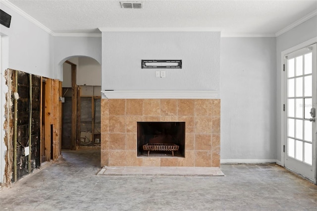 106 13th Ave, St Pete Beach, FL 33706 - unfurnished living room with a tile fireplace, crown molding, and arched walkways