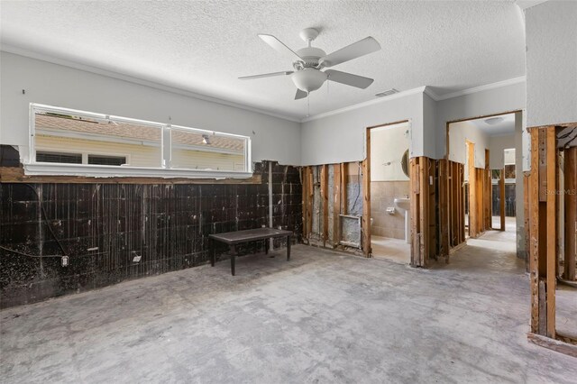 106 13th Ave, St Pete Beach, FL 33706 - bedroom with unfinished concrete flooring, ornamental molding, a wainscoted wall, a textured ceiling, and a ceiling fan
