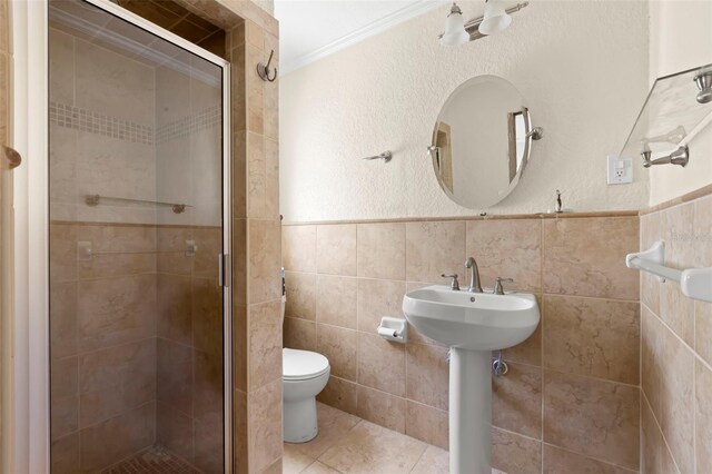 106 13th Ave, St Pete Beach, FL 33706 - full bath featuring a shower stall, tile walls, crown molding, and tile patterned flooring
