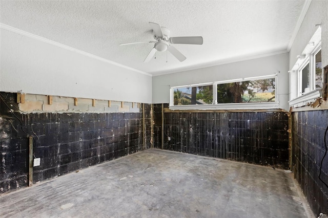 106 13th Ave, St Pete Beach, FL 33706 - spare room featuring a textured ceiling, a ceiling fan, concrete floors, and ornamental molding