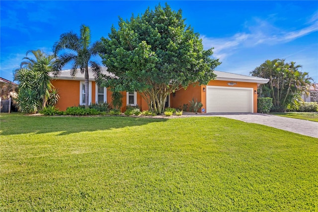1960 Montana Ave NE, Saint Petersburg, FL 33703 - obstructed view of property featuring a garage, stucco siding, driveway, and a front lawn