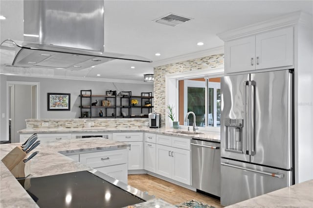 1960 Montana Ave NE, Saint Petersburg, FL 33703 - kitchen with stainless steel appliances, a sink, range hood, crown molding, and white cabinets