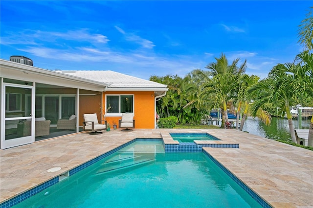 1960 Montana Ave NE, Saint Petersburg, FL 33703 - view of swimming pool with a patio, a sunroom, a pool with connected hot tub, and a water view