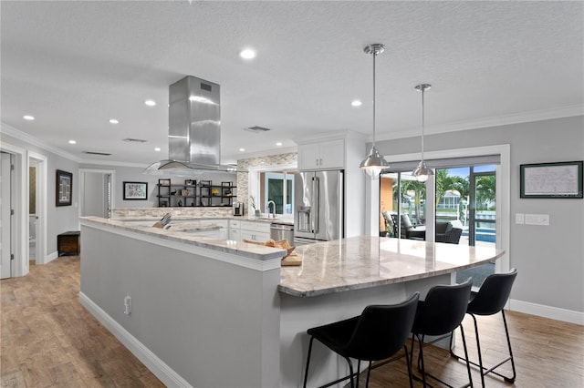 1960 Montana Ave NE, Saint Petersburg, FL 33703 - kitchen featuring appliances with stainless steel finishes, island exhaust hood, a sink, ornamental molding, and baseboards