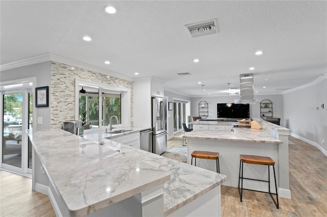 1960 Montana Ave NE, Saint Petersburg, FL 33703 - kitchen featuring a sink, ornamental molding, appliances with stainless steel finishes, recessed lighting, and a kitchen breakfast bar