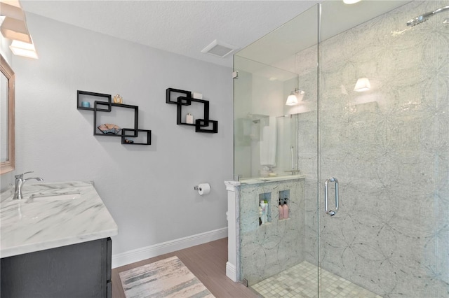 1960 Montana Ave NE, Saint Petersburg, FL 33703 - full bathroom with wood finished floors, baseboards, a marble finish shower, and vanity