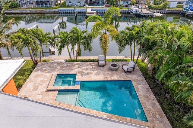1960 Montana Ave NE, Saint Petersburg, FL 33703 - view of pool featuring a patio, a water view, a pool with connected hot tub, and a residential view