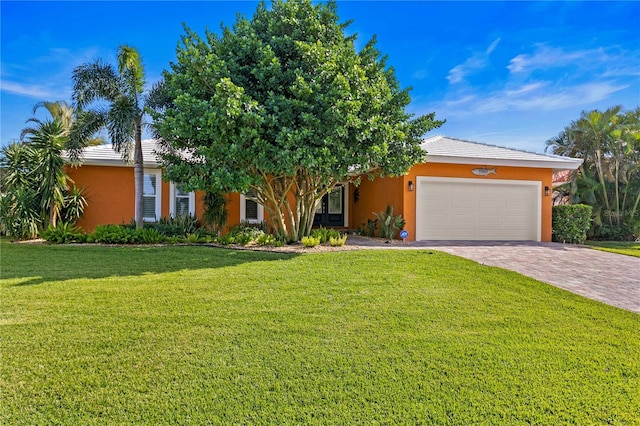 1960 Montana Ave NE, Saint Petersburg, FL 33703 - obstructed view of property featuring stucco siding, an attached garage, driveway, and a front lawn