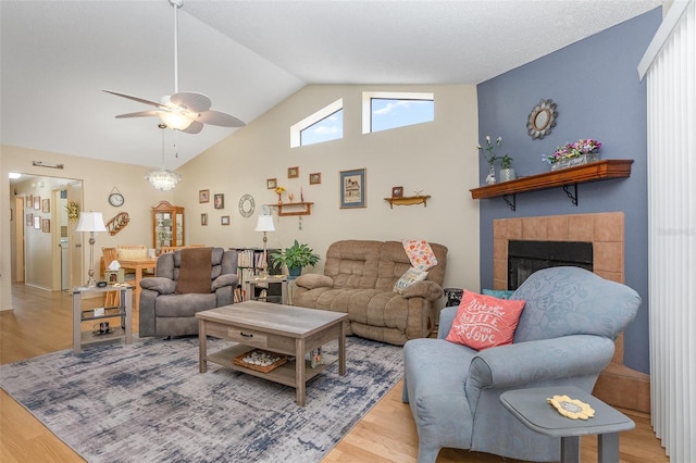 640 Lake Dexter Cir, Winter Haven, FL 33884 - living room with wood finished floors, lofted ceiling, a ceiling fan, and a fireplace