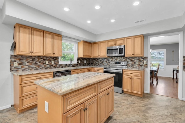 13533 Bay Lake Ln, Tampa, FL 33618 - kitchen with appliances with stainless steel finishes, light wood-style flooring, recessed lighting, light stone counters, and backsplash