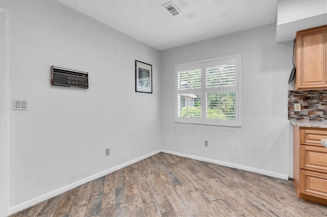 13533 Bay Lake Ln, Tampa, FL 33618 - unfurnished dining area featuring light wood finished floors and baseboards