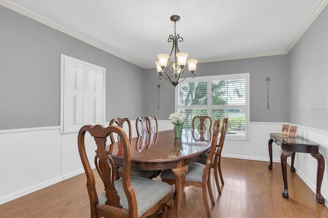 13533 Bay Lake Ln, Tampa, FL 33618 - dining space with a chandelier, wood finished floors, and ornamental molding