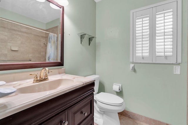 13533 Bay Lake Ln, Tampa, FL 33618 - full bathroom with tile patterned flooring, vanity, toilet, a shower with curtain, and baseboards