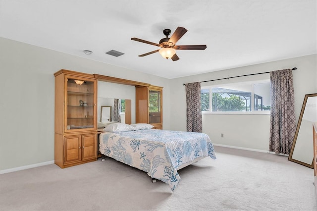 13533 Bay Lake Ln, Tampa, FL 33618 - bedroom featuring baseboards, light carpet, and a ceiling fan
